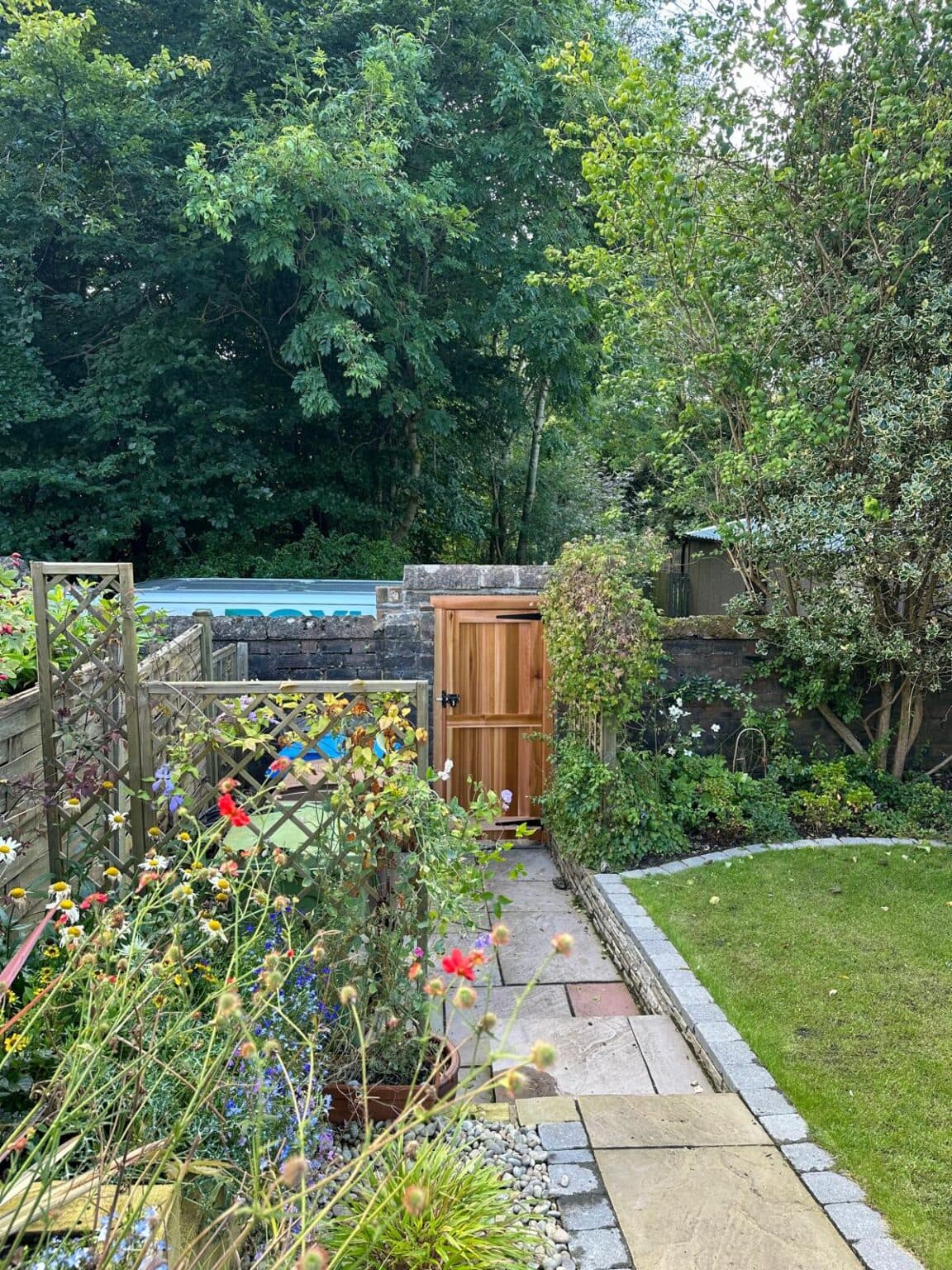 Timber garden gate fitted in a stone boundary wall